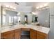 Spacious bathroom featuring double sinks, a vanity area, and ample lighting above the vanities at 5132 E Grandview Rd, Scottsdale, AZ 85254