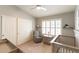 Bedroom with neutral color palette, ceiling fan, plantation shutters, a crib, and an armchair at 5132 E Grandview Rd, Scottsdale, AZ 85254