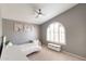 Cozy bedroom with a ceiling fan, vaulted ceilings, window with plantation shutters, and charming decor at 5132 E Grandview Rd, Scottsdale, AZ 85254
