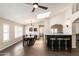 Open concept dining space boasts a modern chandelier, breakfast bar, and vaulted ceilings with natural lighting at 5132 E Grandview Rd, Scottsdale, AZ 85254