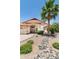 Inviting single-story home with mature landscaping, desert rock features, and an attached two-car garage at 5132 E Grandview Rd, Scottsdale, AZ 85254