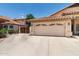 Attached two-car garage with a driveway and partial view of the well maintained desert landscaping at 5132 E Grandview Rd, Scottsdale, AZ 85254