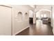 Hallway with tiled floors, arched entryways, and recessed wall niches lead to the living spaces at 5132 E Grandview Rd, Scottsdale, AZ 85254