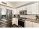Spacious kitchen with stainless steel appliances, white cabinets, and granite countertops at 5132 E Grandview Rd, Scottsdale, AZ 85254