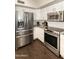 Modern kitchen featuring stainless steel appliances and white cabinetry at 5132 E Grandview Rd, Scottsdale, AZ 85254
