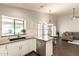 Modern kitchen with granite countertops, stainless appliances, and open to the dining and living areas at 5132 E Grandview Rd, Scottsdale, AZ 85254