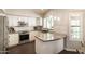 Bright kitchen featuring stainless steel appliances, granite countertops, and white cabinetry at 5132 E Grandview Rd, Scottsdale, AZ 85254