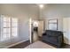 A living room with shutters, a gray sofa, a light area rug, and an open doorway at 5132 E Grandview Rd, Scottsdale, AZ 85254
