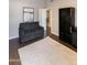 Living room with dark wood floors, a gray sofa, an area rug, and a dark bookshelf at 5132 E Grandview Rd, Scottsdale, AZ 85254