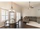 Bright living area features a modern ceiling fan, grey sectional, and a dining area near the window shutters at 5132 E Grandview Rd, Scottsdale, AZ 85254