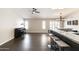 Spacious living area with dark tile floors, a breakfast bar, and ample natural light from window shutters at 5132 E Grandview Rd, Scottsdale, AZ 85254