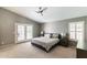 Serene main bedroom with neutral tones, vaulted ceiling, and access to an outdoor patio with shuttered doors at 5132 E Grandview Rd, Scottsdale, AZ 85254