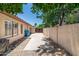 Spacious side yard with a concrete walkway, mature landscaping, and a wooden gate for added privacy at 5132 E Grandview Rd, Scottsdale, AZ 85254