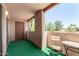 This balcony features outdoor seating and a view of palm trees under a clear, sunny sky at 540 N May -- # 3117, Mesa, AZ 85201