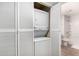 Bathroom closet featuring a stacked washer and dryer, with a toilet and shower visible at 540 N May -- # 3117, Mesa, AZ 85201