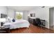 Bedroom with wood floors, a TV, desk and a large window at 540 N May -- # 3117, Mesa, AZ 85201