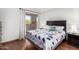 Bedroom featuring wood floors, bedside tables, and a sliding glass door at 540 N May -- # 3117, Mesa, AZ 85201