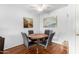 Dining area featuring a round table with four chairs, decorative artwork, and a view of the kitchen at 540 N May -- # 3117, Mesa, AZ 85201