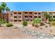 Multi-story apartment complex with tile roofing, multiple windows and balconies and desert landscaping at 540 N May -- # 3117, Mesa, AZ 85201