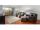 Cozy living room featuring a sofa, accent chair, and a sliding glass door leading to a balcony at 540 N May -- # 3117, Mesa, AZ 85201