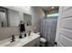 Bathroom featuring double sinks, modern black fixtures, and a shower-tub combination for convenience at 5490 W Trenton Way, Florence, AZ 85132