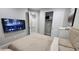 Comfortable bedroom with wood-look floors, a TV, and a spacious closet at 5490 W Trenton Way, Florence, AZ 85132