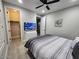 Inviting bedroom with wood-look floors, a ceiling fan, and a walk-in closet for organized storage at 5490 W Trenton Way, Florence, AZ 85132