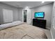 Spacious bedroom featuring neutral walls, light floors, plantation shutters, and a TV for relaxing at 5490 W Trenton Way, Florence, AZ 85132