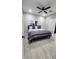 Bedroom features light floors, a ceiling fan, and modern decor for a tranquil living space at 5490 W Trenton Way, Florence, AZ 85132