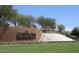 Beautiful Anthem by Del Webb brick signage with a cascading water feature and lush green landscaping at 5490 W Trenton Way, Florence, AZ 85132