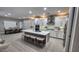 Open-concept kitchen and dining area with a large island, seating, and modern appliances at 5490 W Trenton Way, Florence, AZ 85132