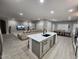 Bright, open-concept living room and kitchen with modern finishes, an island, and an attached dining area at 5490 W Trenton Way, Florence, AZ 85132