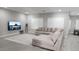 Bright living room with a large sectional sofa, TV, and natural lighting at 5490 W Trenton Way, Florence, AZ 85132