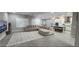 Spacious living room with plush sectional sofa, large windows with shutters, and an open flow to the kitchen at 5490 W Trenton Way, Florence, AZ 85132