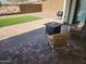 Inviting brick patio with a cozy fire pit and comfortable seating, perfect for outdoor entertaining at 5490 W Trenton Way, Florence, AZ 85132