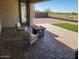 Relaxing patio with fire pit, comfortable seating and a view of the landscaped backyard at 5490 W Trenton Way, Florence, AZ 85132