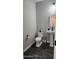 Half bath featuring elegant pedestal sink, sleek fixtures, and modern tile flooring for a stylish touch at 5490 W Trenton Way, Florence, AZ 85132