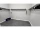 Simple walk-in closet with white wire shelving and gray flooring, providing ample storage space at 5490 W Trenton Way, Florence, AZ 85132