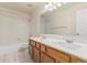Well-lit bathroom features double sinks, tub, and shower combination at 6032 W Grovers Ave, Glendale, AZ 85308