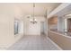 Charming dining area with a chandelier, tile floors, and easy access to the kitchen at 6032 W Grovers Ave, Glendale, AZ 85308