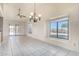 Bright dining area with tile flooring, chandelier, and sliding glass doors leading to the backyard at 6032 W Grovers Ave, Glendale, AZ 85308