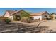 Beige single-story house showcasing desert landscaping, foliage, and a driveway at 6032 W Grovers Ave, Glendale, AZ 85308