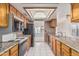 Well-lit kitchen featuring granite countertops, tile floors, and access to the backyard at 6032 W Grovers Ave, Glendale, AZ 85308
