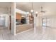 Open kitchen and dining area featuring tile floors and a view of the backyard through sliding glass doors at 6032 W Grovers Ave, Glendale, AZ 85308