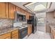 Traditional kitchen featuring wood cabinets, granite countertops, and appliances, perfect for cooking and entertaining at 6032 W Grovers Ave, Glendale, AZ 85308