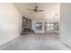 Spacious living room featuring a stone fireplace, ceiling fan, and a bay window overlooking a pool at 6032 W Grovers Ave, Glendale, AZ 85308