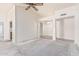 Open-concept living room with vaulted ceilings and ample natural light streaming through the windows at 6032 W Grovers Ave, Glendale, AZ 85308