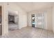 Open living space with tile floors, access to the pool area, and a view of the stone fireplace at 6032 W Grovers Ave, Glendale, AZ 85308