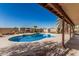 Inviting backyard pool featuring a cool deck and mature palm trees at 6032 W Grovers Ave, Glendale, AZ 85308