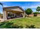 A well-maintained backyard showcasing a covered patio area with outdoor seating at 7231 W Lone Cactus Dr, Glendale, AZ 85308